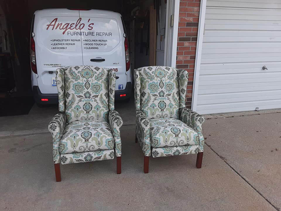 two clean and repaired chairs ina driveway with a work van behind